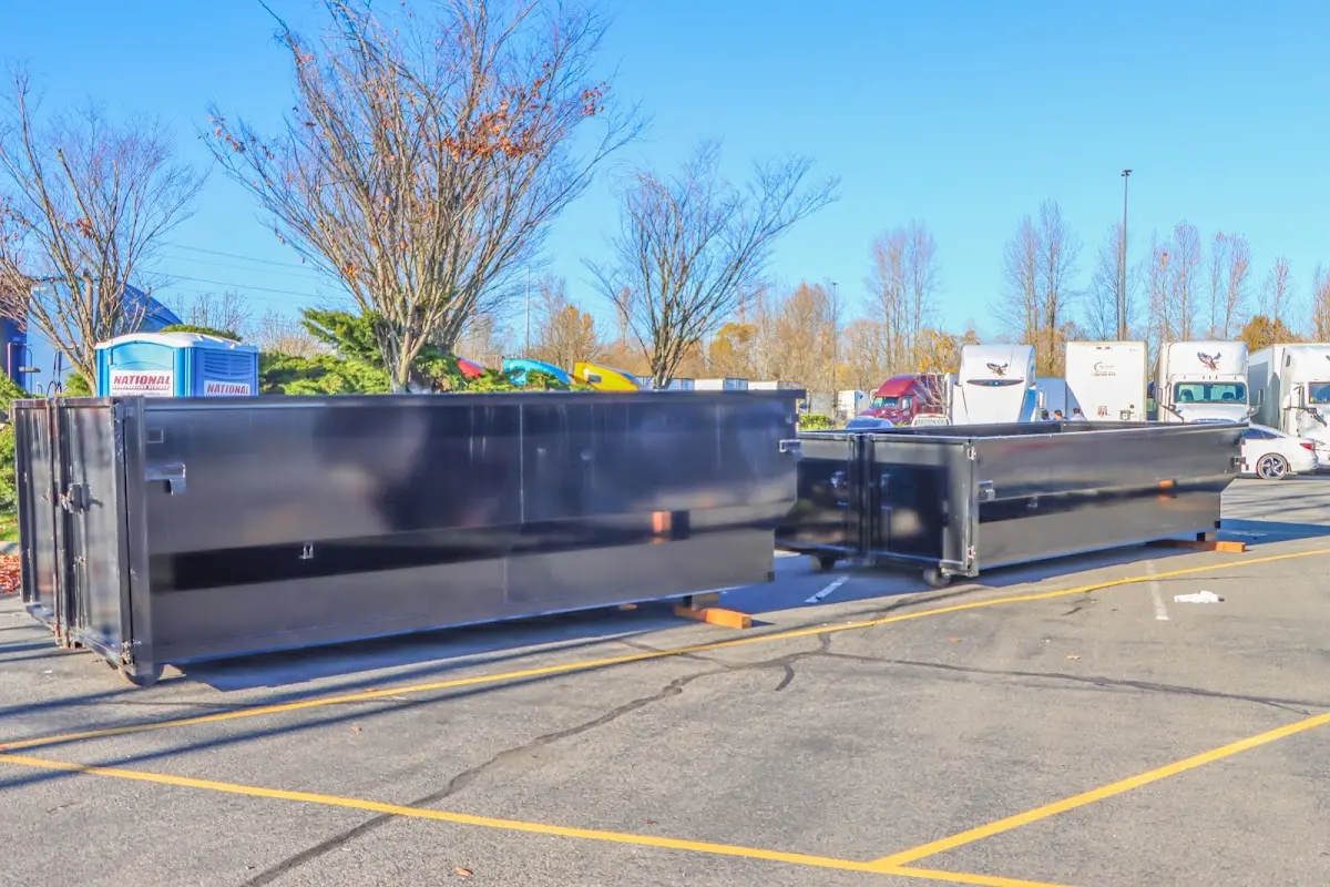 Professional dumpster rental service with roll-off container on residential driveway in Birmingham